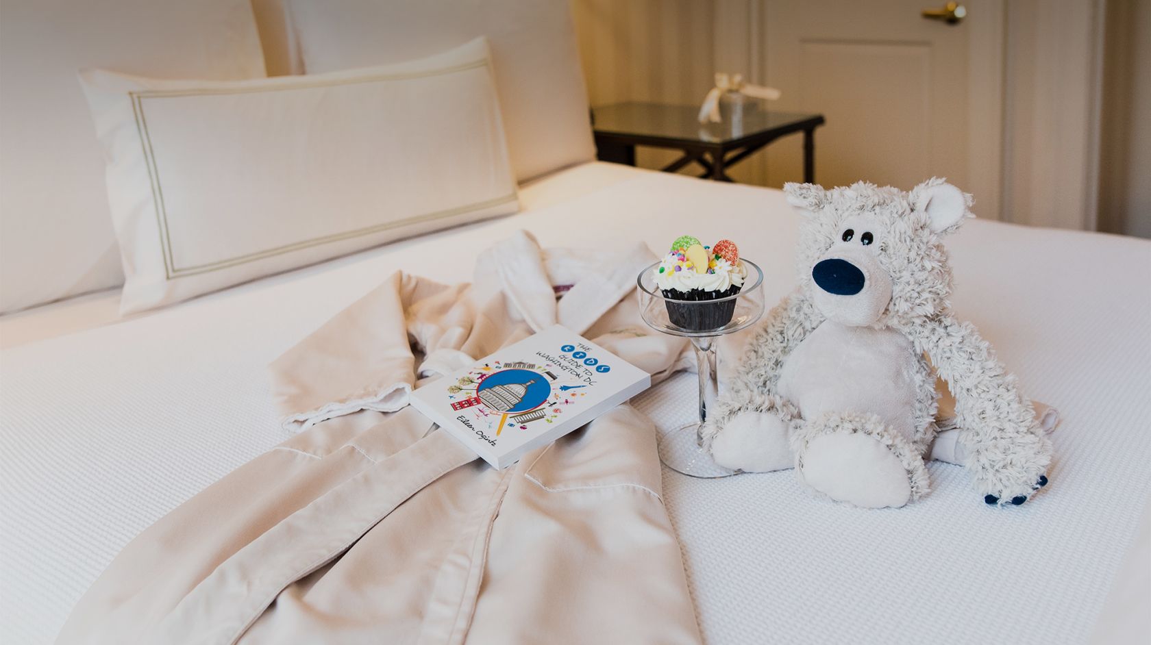 A Stuffed Animal Sitting On A Bed