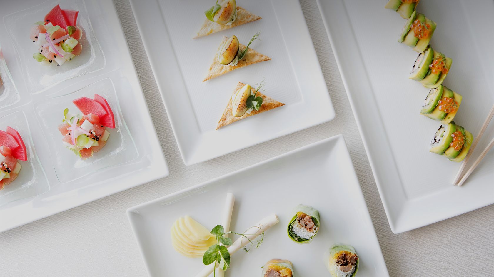 white plates of appetizers on a table