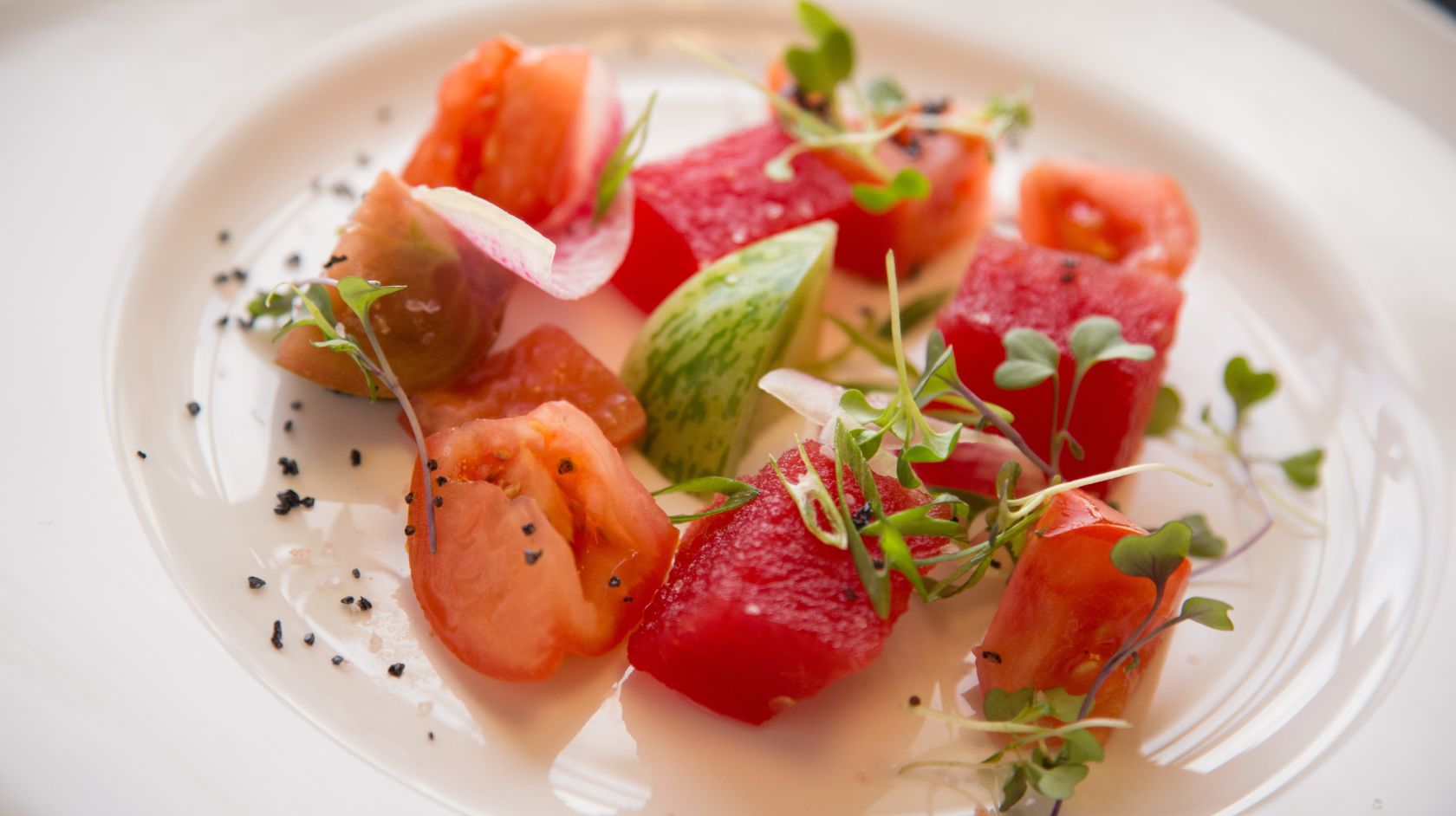A white plate with watermelon salad
