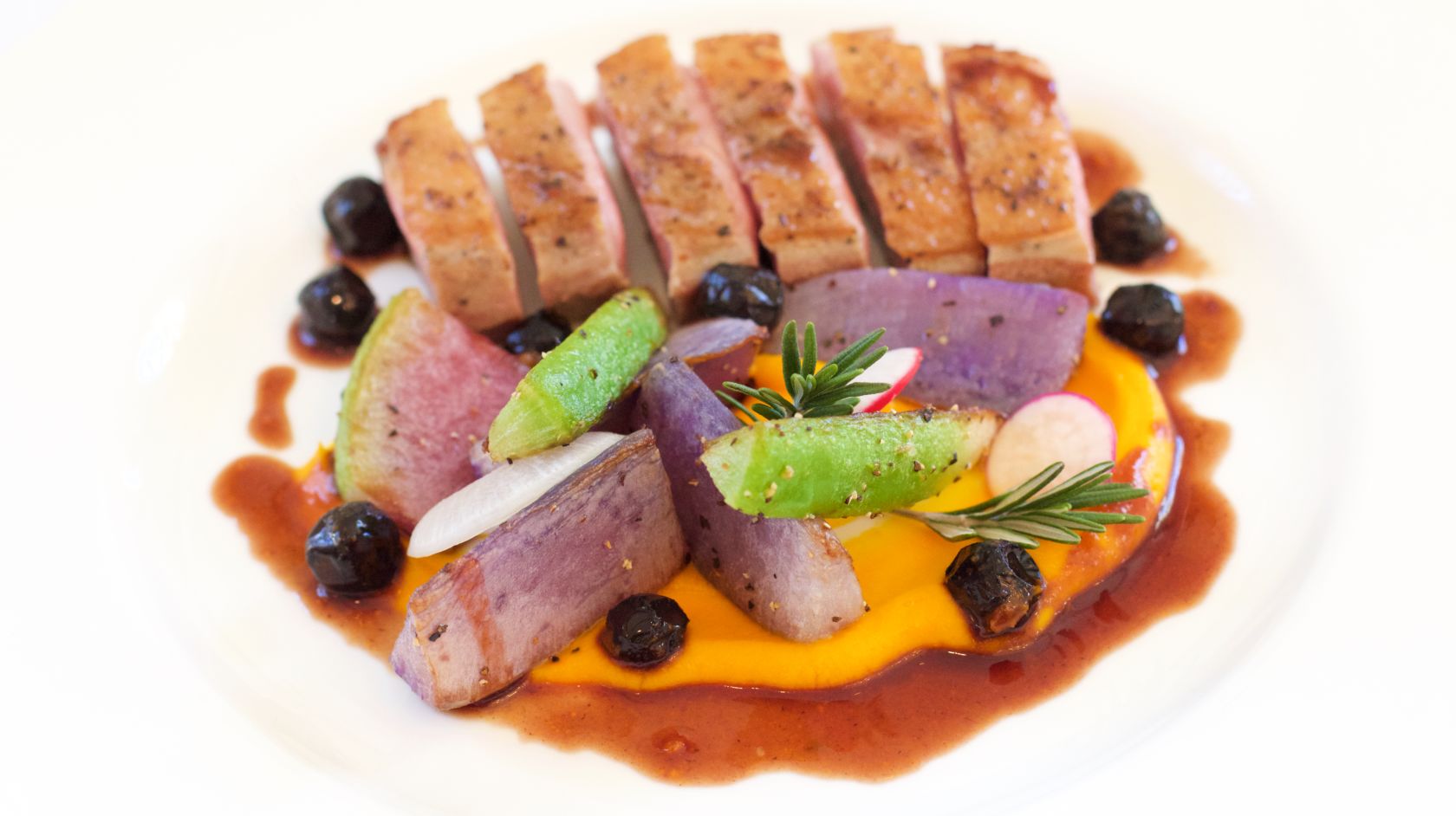 A sliced duck entree on a plate